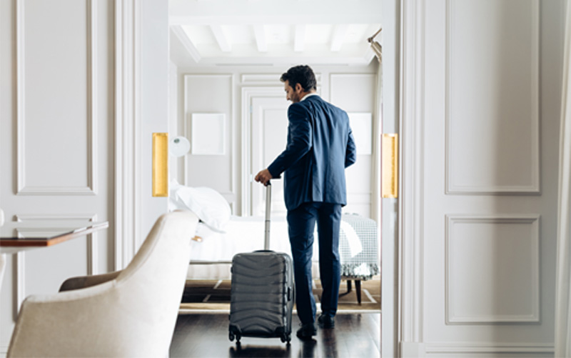 Business traveler in a hotel room with HSBC’s corporate solutions Business traveler in a hotel room with HSBC’s corporate solutions